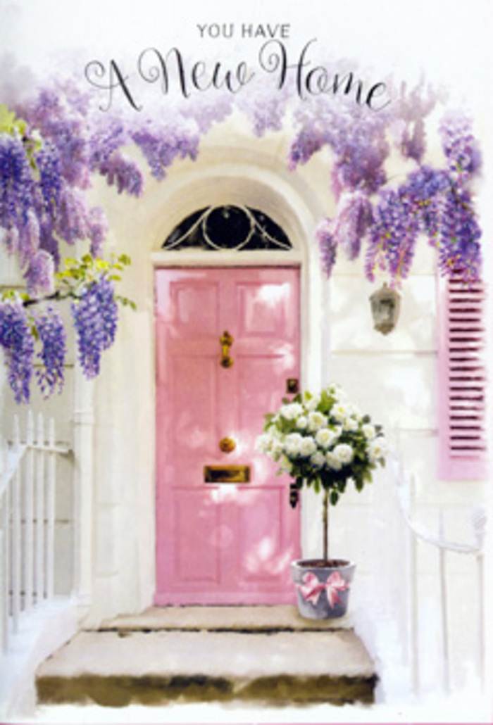 The photograph captures a soothing entrance scene that could easily sit along one of Dartford's quieter lanes, perhaps a side street off Princes Road, freshly adorned to mark someone's move into a new home. At its centre is a painted pink front door, rendered in a gentle, chalky blush that appears soft and welcoming under the clear daylight. A single shutter echoes that same pastel tone, framing the doorway and creating a sense of cohesion that feels both modern and cosy. Overhead, wisteria drapes in loose, romantic skeins of lavender, lilac, and soft purple, the clustered blooms hanging like airy tassels that almost graze the top of the door. Their presence adds a sense of age and established charm, as if this house has long been tended by someone who loves flowers. The wall behind is whitewashed, its slightly rough texture catching the light and creating subtle shadows that help define each petal and leaf. Set neatly on the doorstep, a sturdy grey bucket acts as a relaxed yet stylish vase for a generously packed bouquet of white and cream roses. The roses are fully open, with thick, velvety petals that curl at the edges, giving each bloom a plush, almost cushion-like quality. Between them, soft green foliage pokes through, adding texture and slight height differences that keep the arrangement from feeling static. A soft pink ribbon is tied gracefully around the bucket, its bow and long tails resting lightly against the metal, mirroring the blush tones of the door and shutter. Light filters gently through the wisteria canopy above, casting delicate, shifting patterns onto the stone step. Altogether, the image suggests a Dartford home on its very first day of welcome, with flowers chosen to steady any moving-day nerves and to fill the threshold with serenity and hope.
